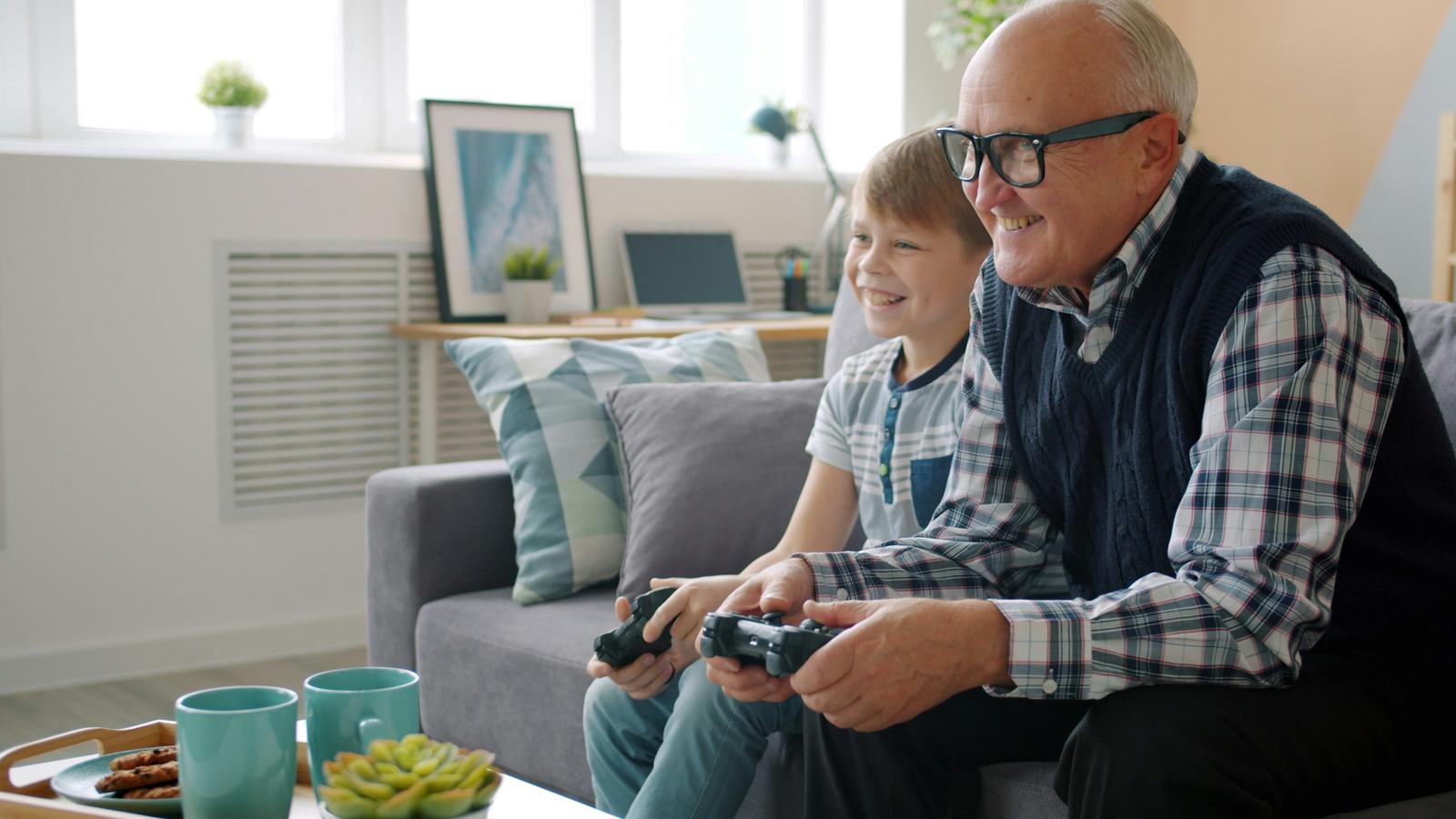 Grandfather and grandson playing video games together