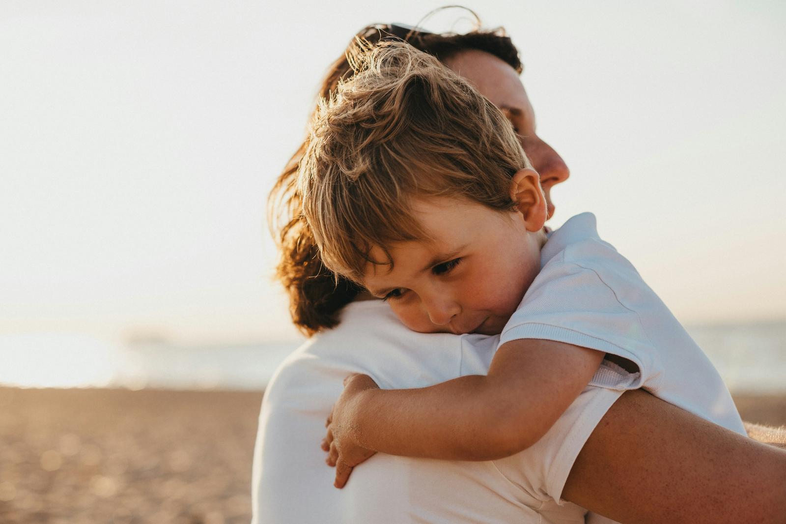 Parent hugging child on the beach